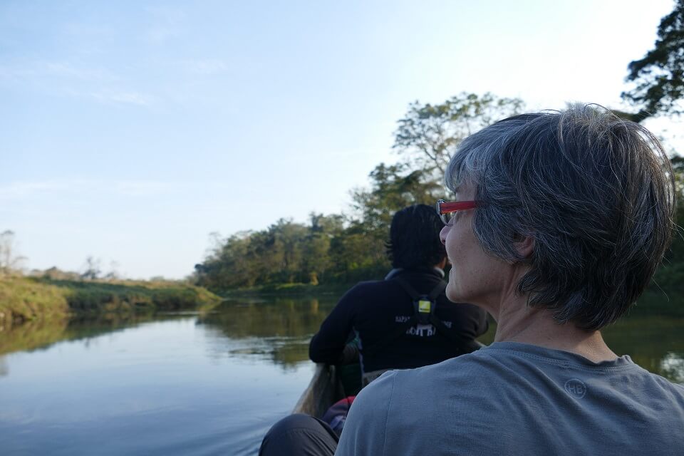 Traveler on boat safari in Chitwan National Park
